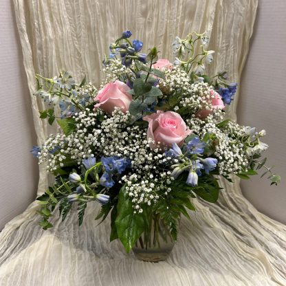 Bouquet with pink roses and blue delphinium